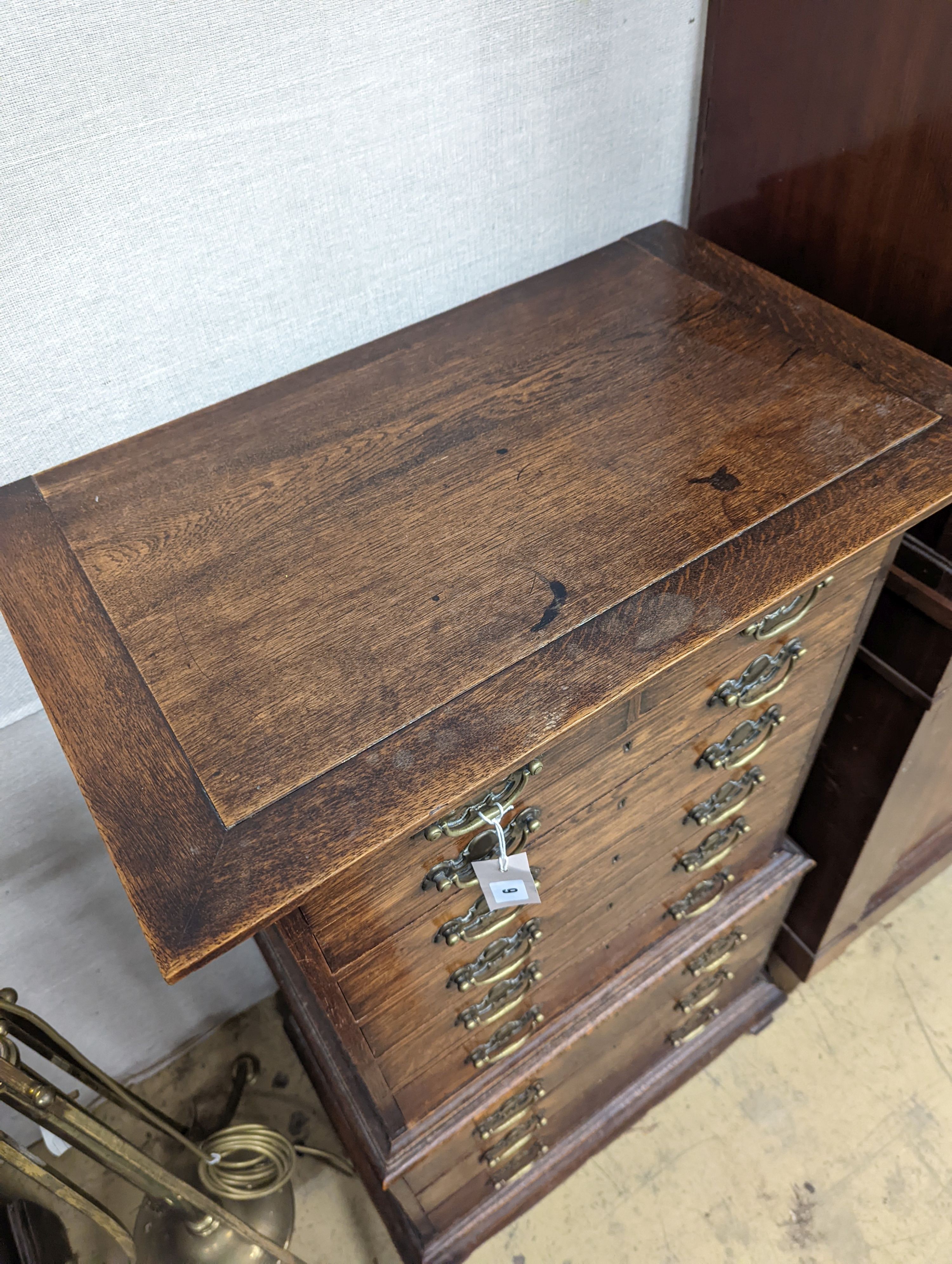 A small early 20th century oak tall chest, fitted ten drawers, width 60cm, depth 37cm, height 111cm